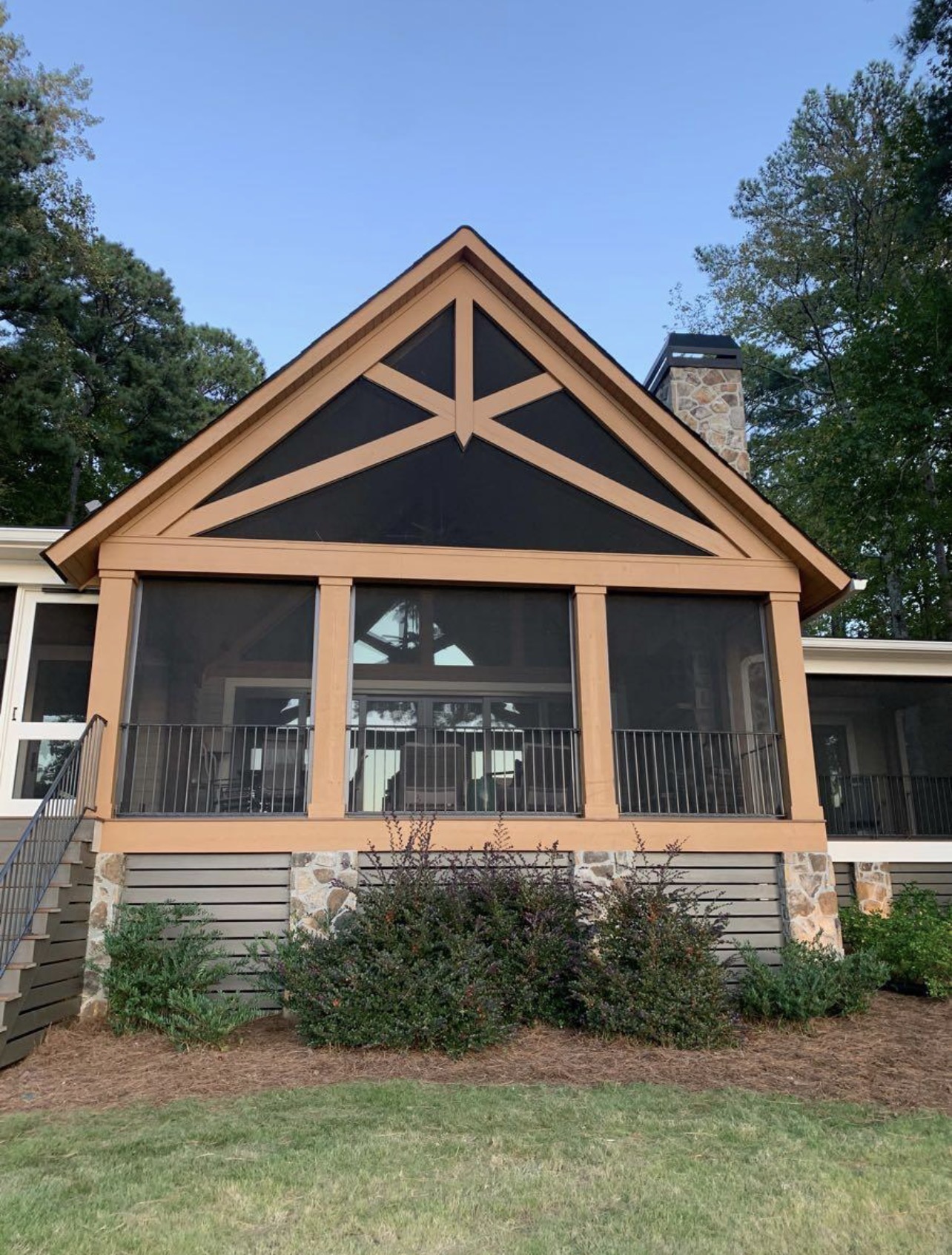 Screened porch with stained wood trim and decorative gable