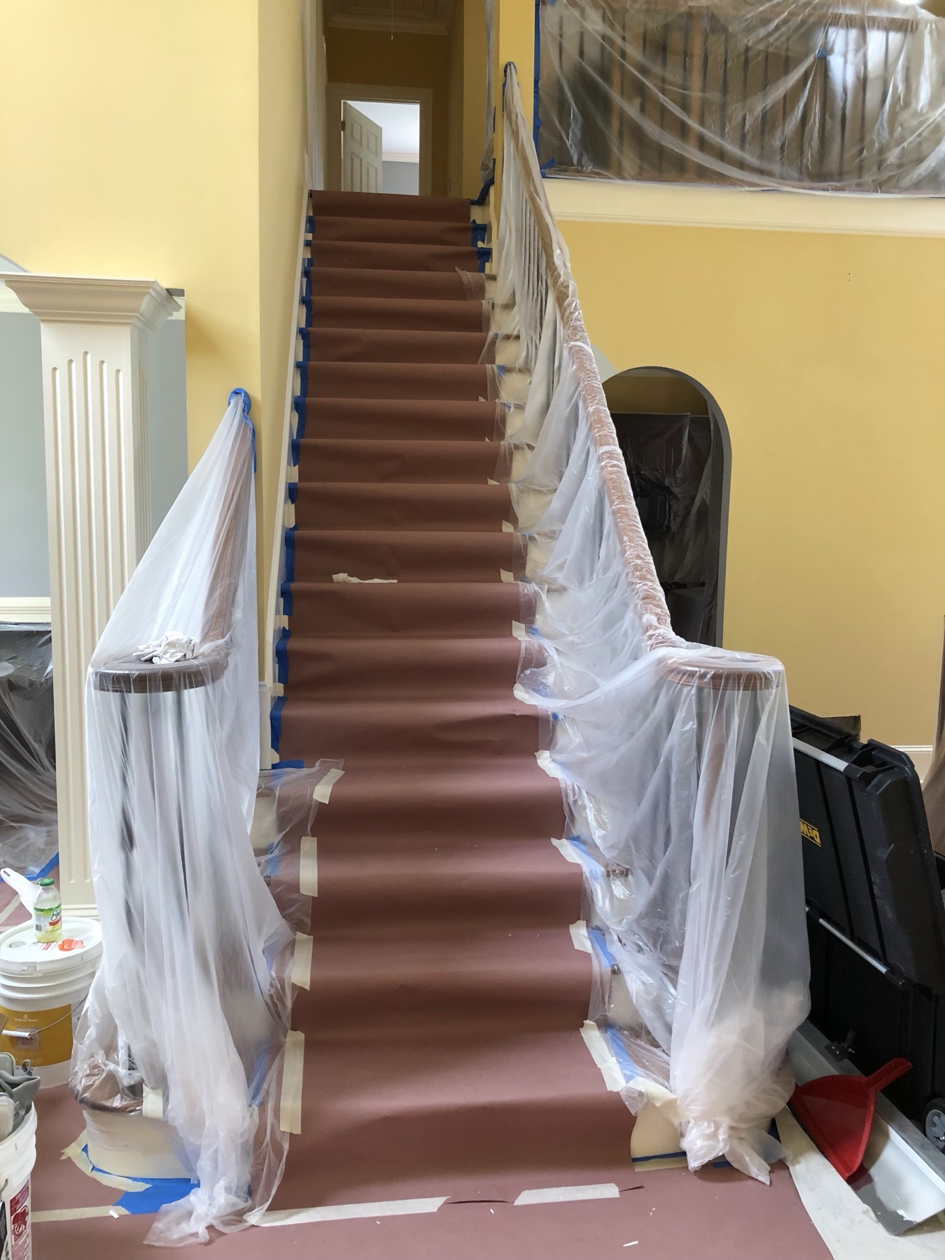 Grand staircase and railings fully masked and protected before painting